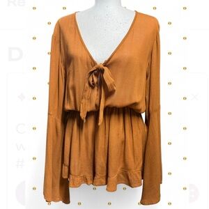 Nasty Gal gold/mustard long sleeve open front tie romper with ruffle detailing.